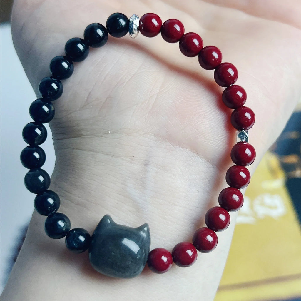 Handmade black obsidian bracelet with cat charm and colourful beads on elastic cord with adjustable ties.