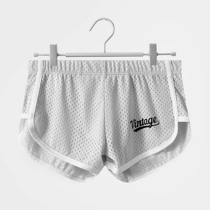 Men's solid colour Ice Silk quick-dry underwear in mid waist style on a grey background.