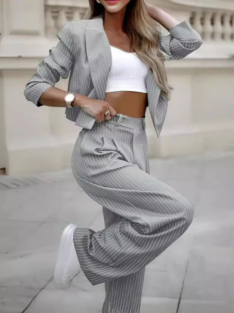 Stylish striped casual suit with cropped top and straight-leg pants in gray, dark blue, and black colors