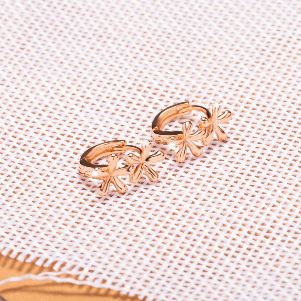 Rose gold circular earrings with a waterdrop flower design.