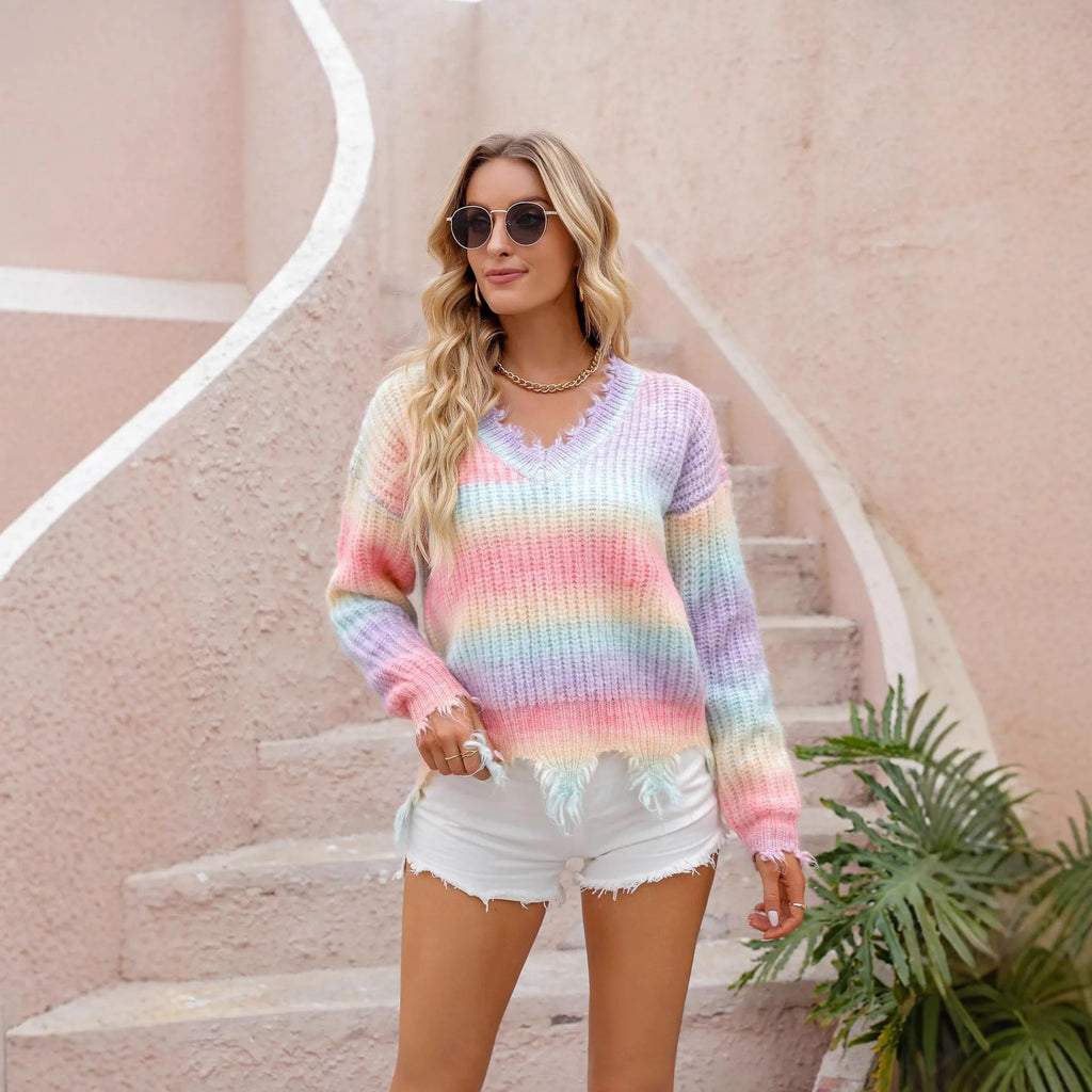 Pink rainbow gradient loose knit sweater with tassel details on hanger