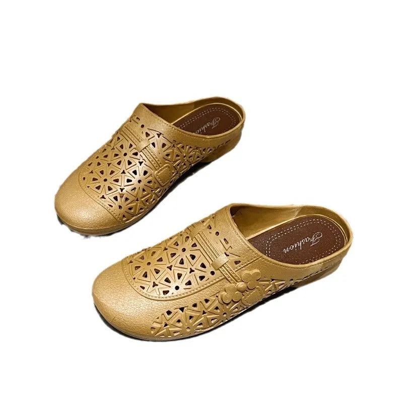 Apricot fairy style flat toe slippers with hollow-out pattern on a white background.