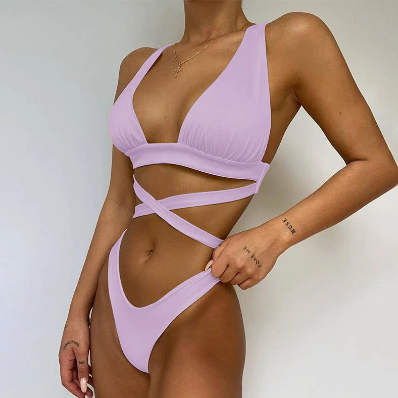 Women's solid colour cross bikini swimsuit with removable chest pads in black, showing front design detail