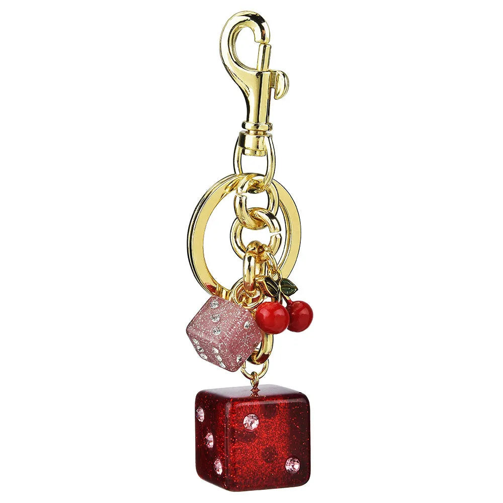 Square metal keychain pendant with a vintage two-tone cherry dice pattern.