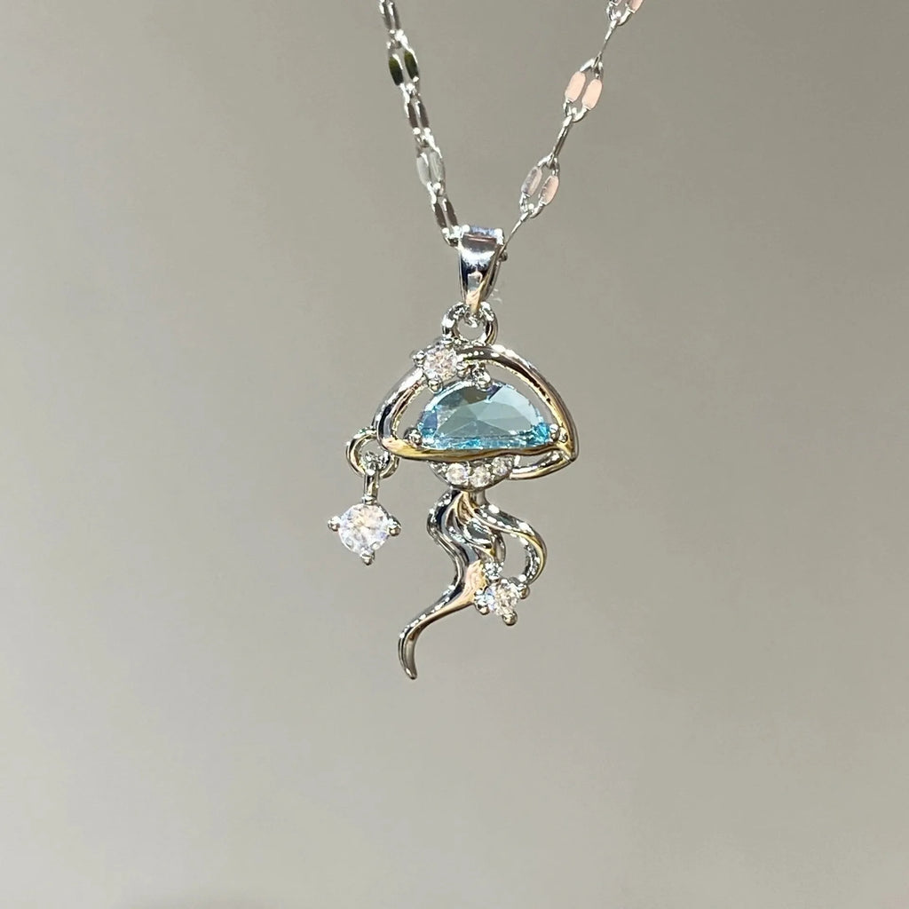 Blue jellyfish pendant on a white gold coloured adjustable sterling silver necklace chain.