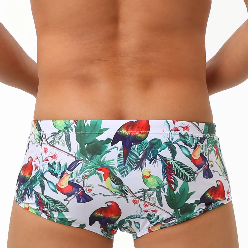Men's floral bird print swim trunks with cup compartment in blue and white design