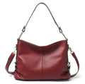 Genuine leather vertical square crossbody bag in black with multiple internal organiser pockets.