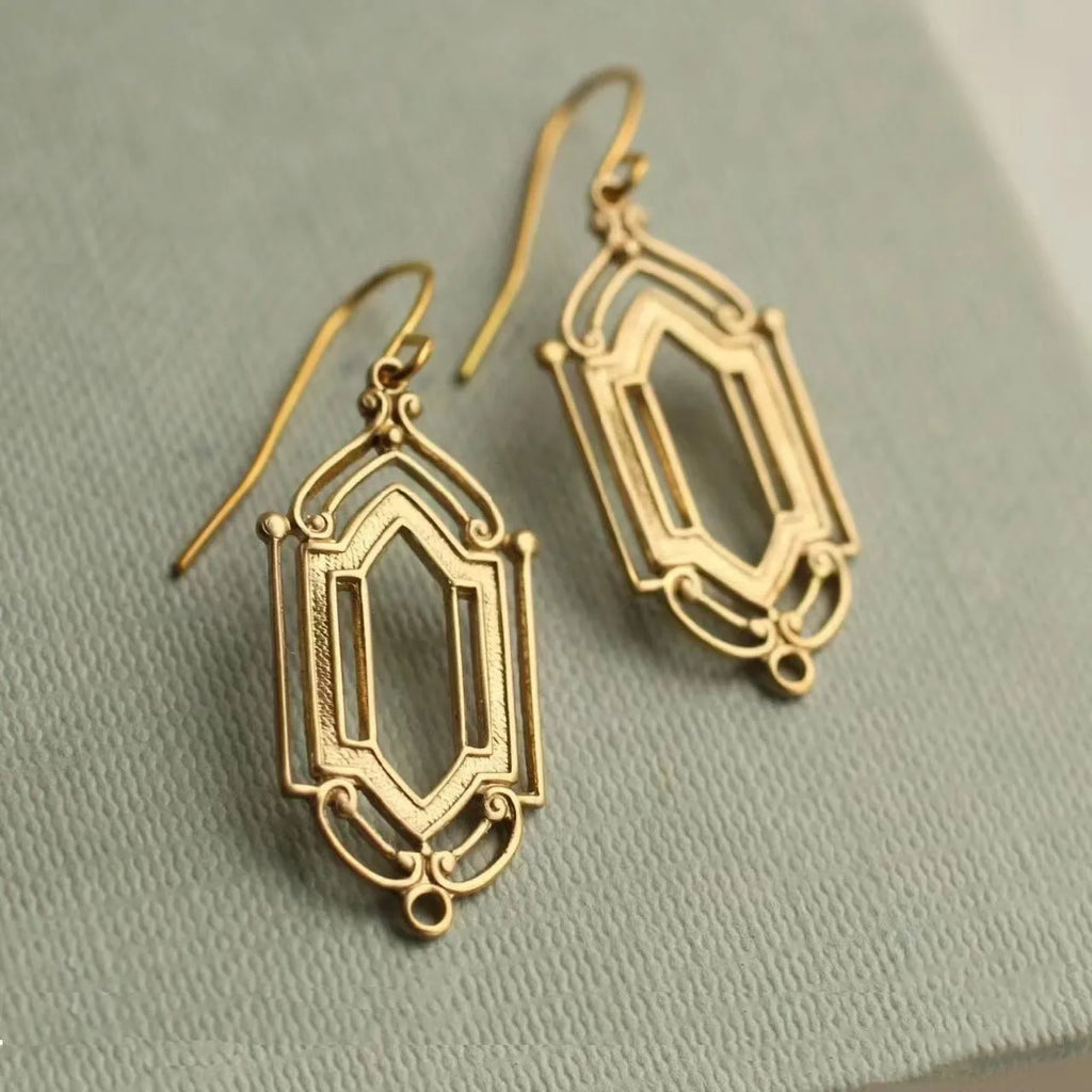 Gold flower window hollow stud earrings with geometric copper design and electroplated brass-style finish