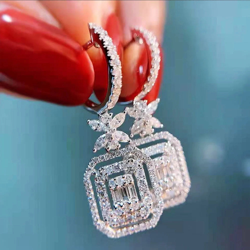 Women's white gold zirconia bow earrings with micro-set stones for a sparkling effect.