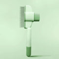 Green and yellow pet grooming brush for dogs with one-click hair removal system