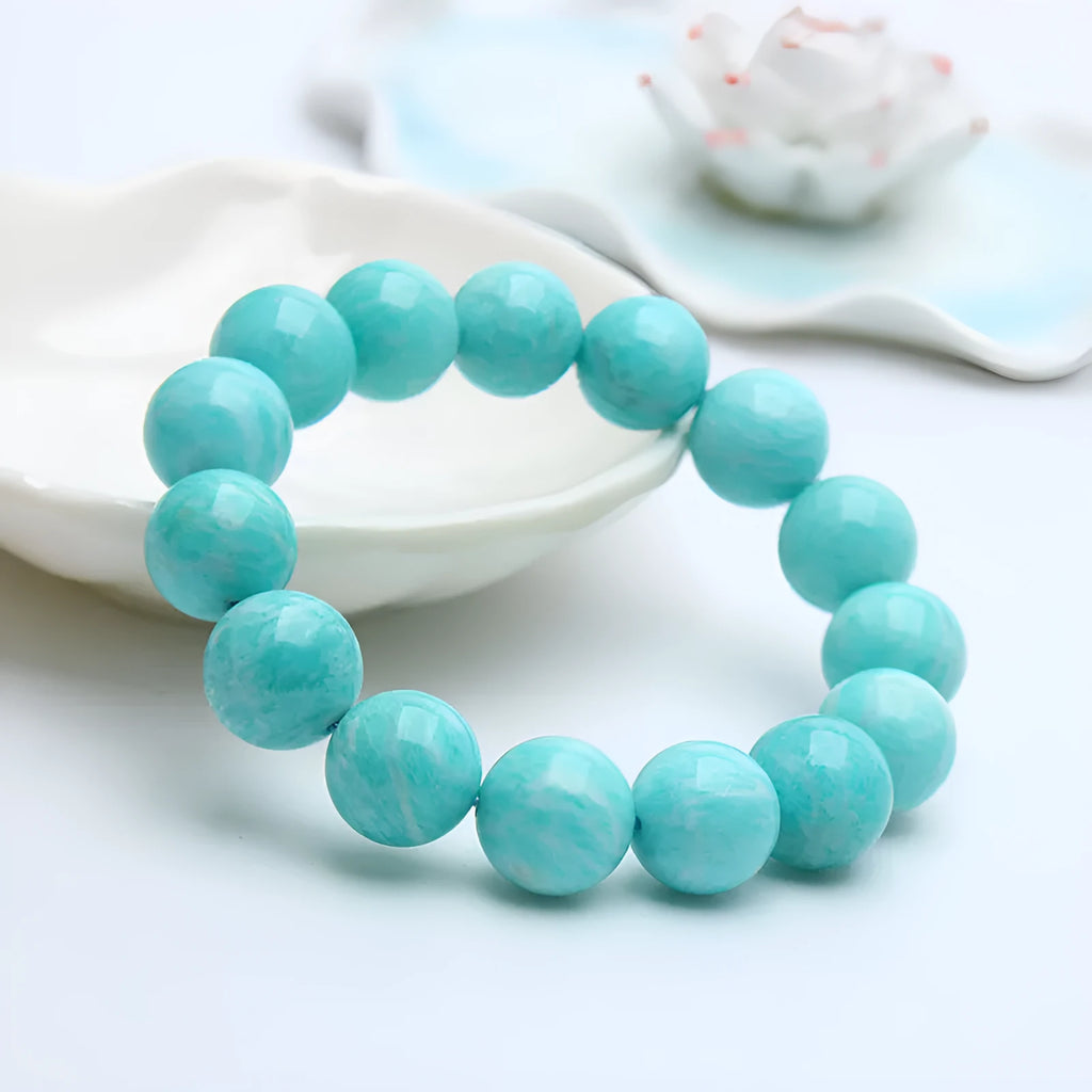 Natural blue-green Amazonite stone bracelet with round beads on an adjustable cord.