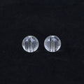 Ten 10mm round crystal prayer beads with Heart Sutra design, polished glass finish, scattered on a surface.