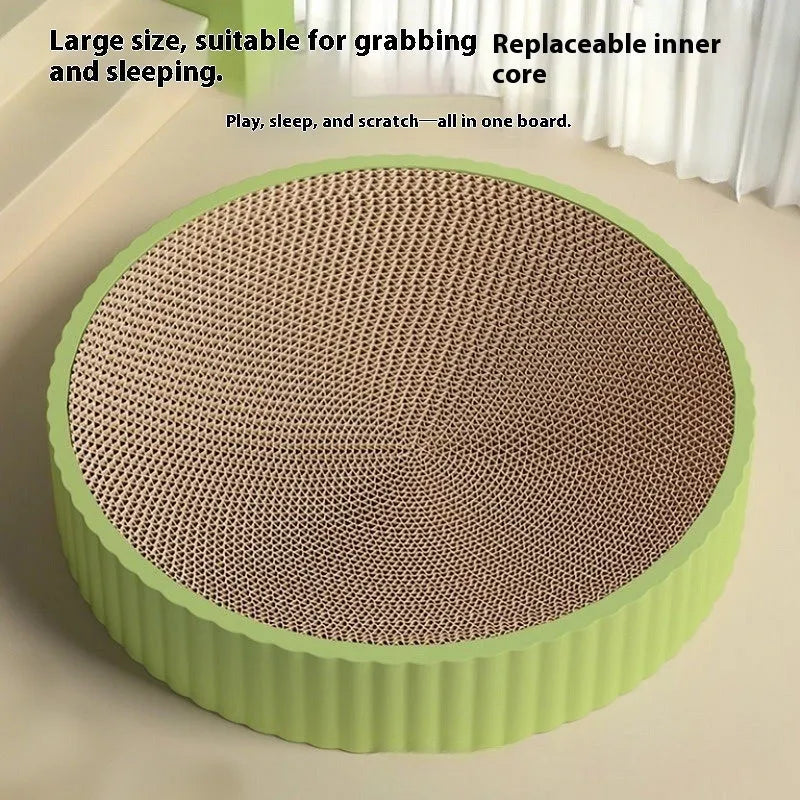 A round green cat scratching board made of corrugated cardboard, 55cm across, with two spare refills.