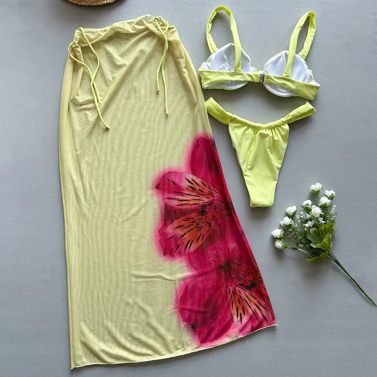 Three-piece women's bikini set in yellow print with split design, nylon fabric, and spandex lining, sizes S, M, L