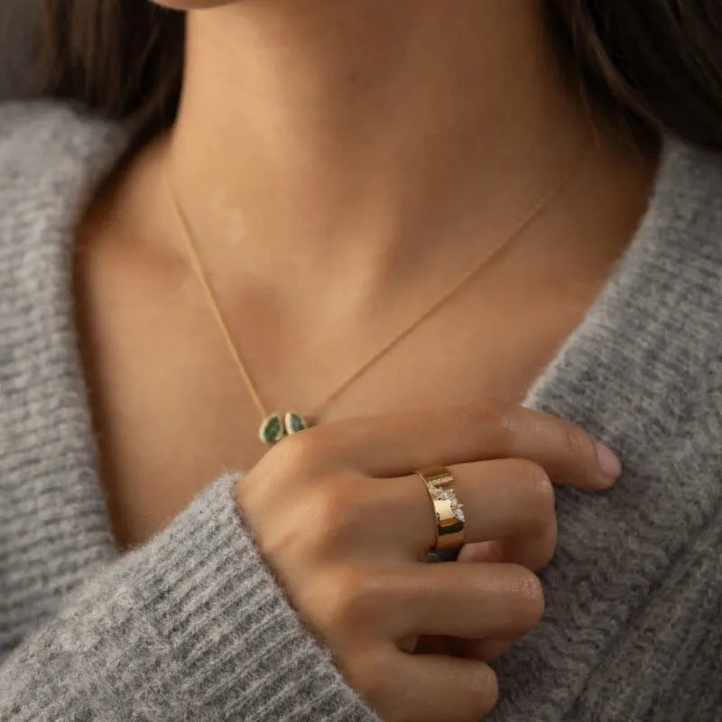 Gold-coloured women's fashion ring with shining zircon stones on a metal band