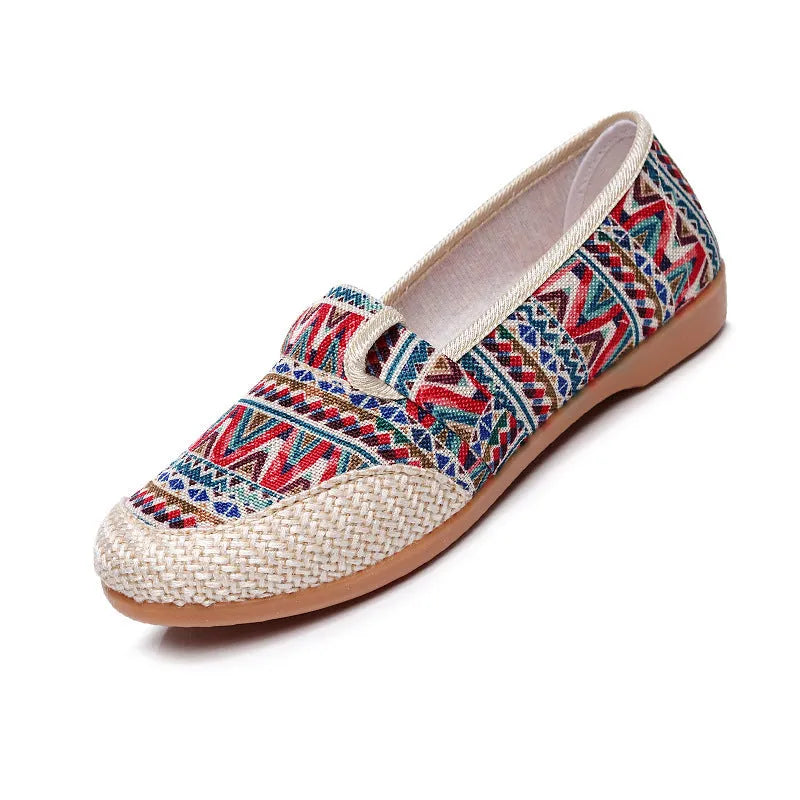 Women's flat heel ethnic cloth shoes in blue with colour stitching detail on a low-top, shallow mouth design.