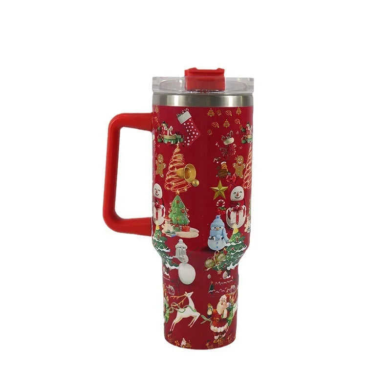 Red Christmas pattern stainless steel travel tumbler with handle, straw, and lid on a table.