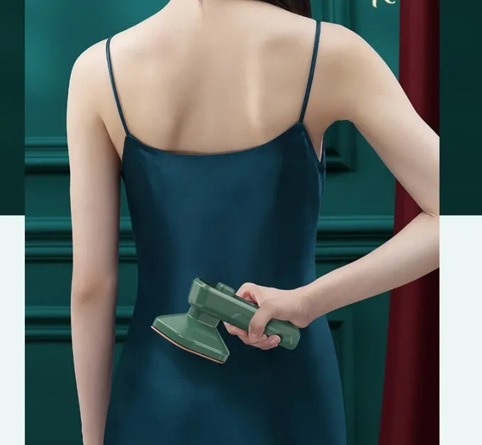 Dark green portable hanging steam iron with ceramic panel and compact design for travel use