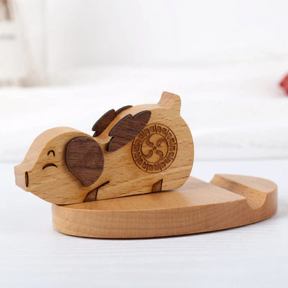 Custom lettering beech wood lazy phone holder with coin slot on a wooden table
