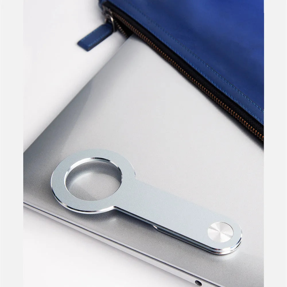 Silver aluminium alloy magnetic extension holder for mobile phones on a desktop.