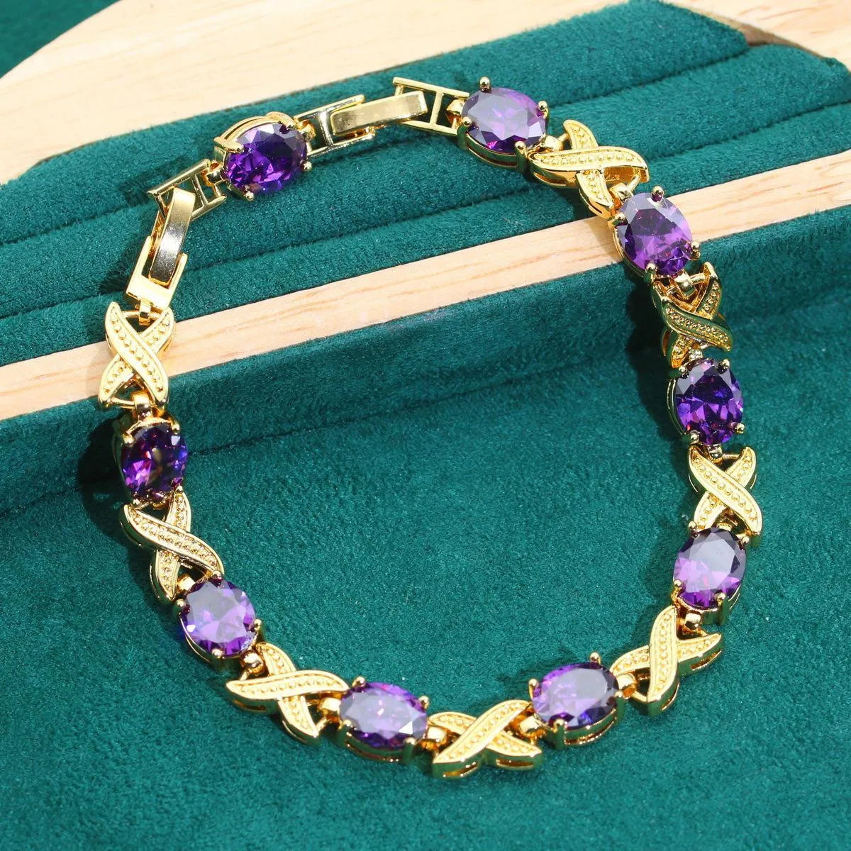 Gold plated jewellery set with coloured cubic zirconia stones showing necklace, earrings, ring, and bracelet.