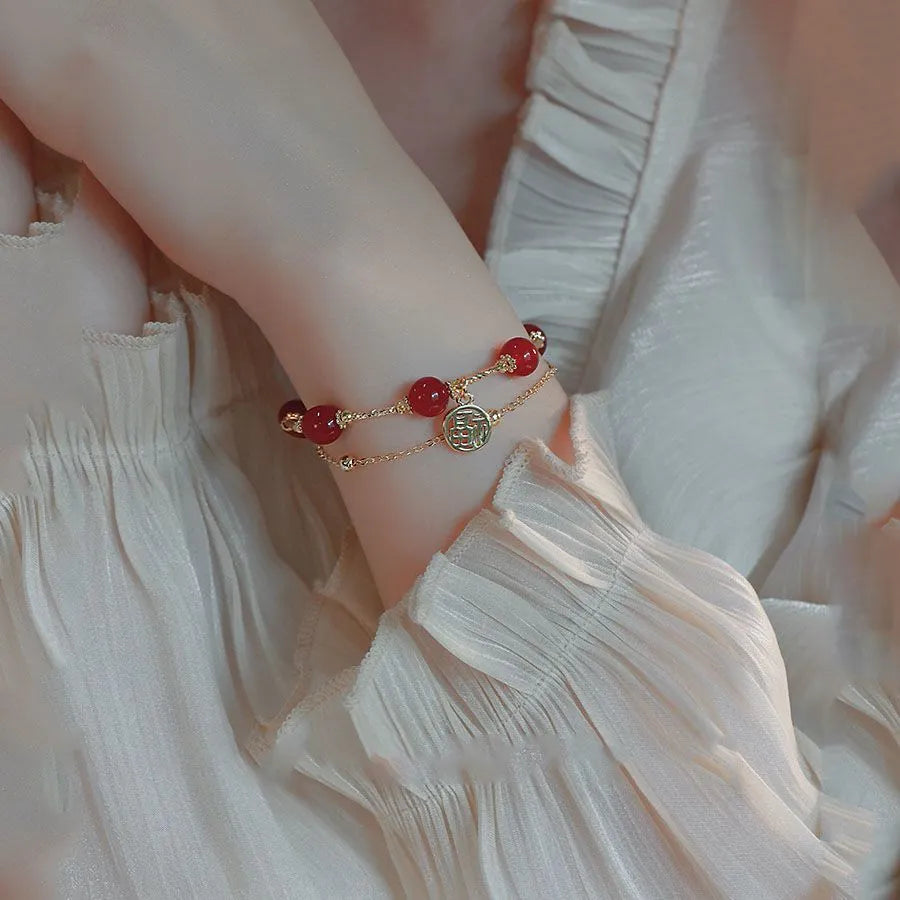 Red agate and alloy double-layer women's bracelet with a Red Horse blessing card charm on a white background.