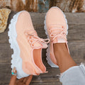 Women's white Flyknit mesh casual sports shoes with flat heel and lace-up front on a neutral background.