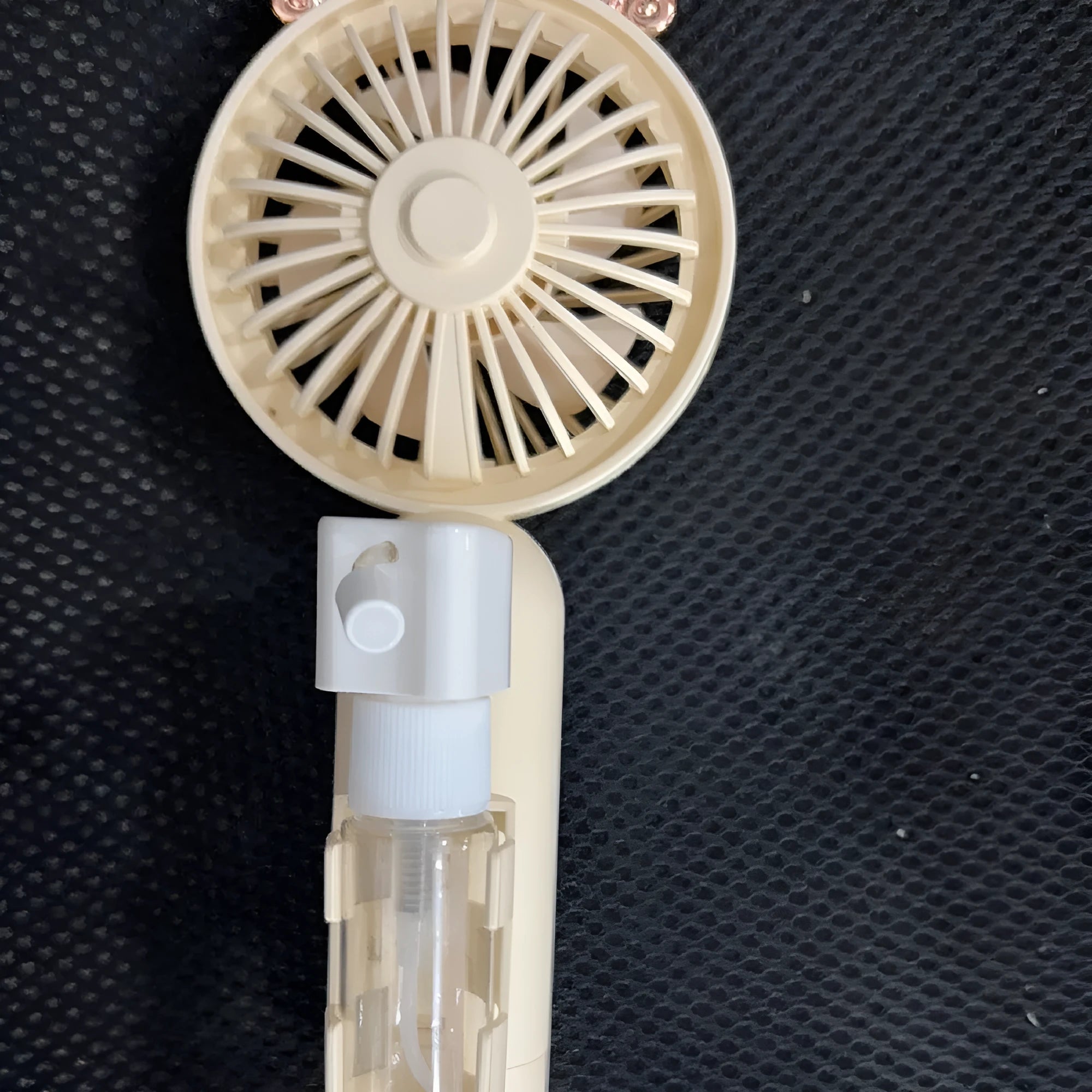 Plastic USB desk fan with adjustable nozzle in apricot colour on wooden desk