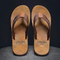 Men's black flip flops with textured non-slip PVC sole and EVA upper on a sandy beach.