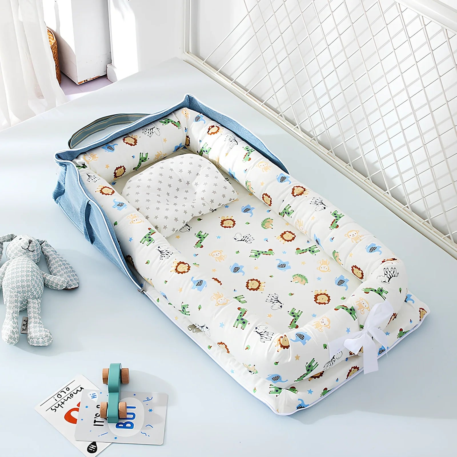 Foldable cotton portable baby crib in Animal World Blue, 90x50 cm with pillow and strap, weighing 1.3 kg