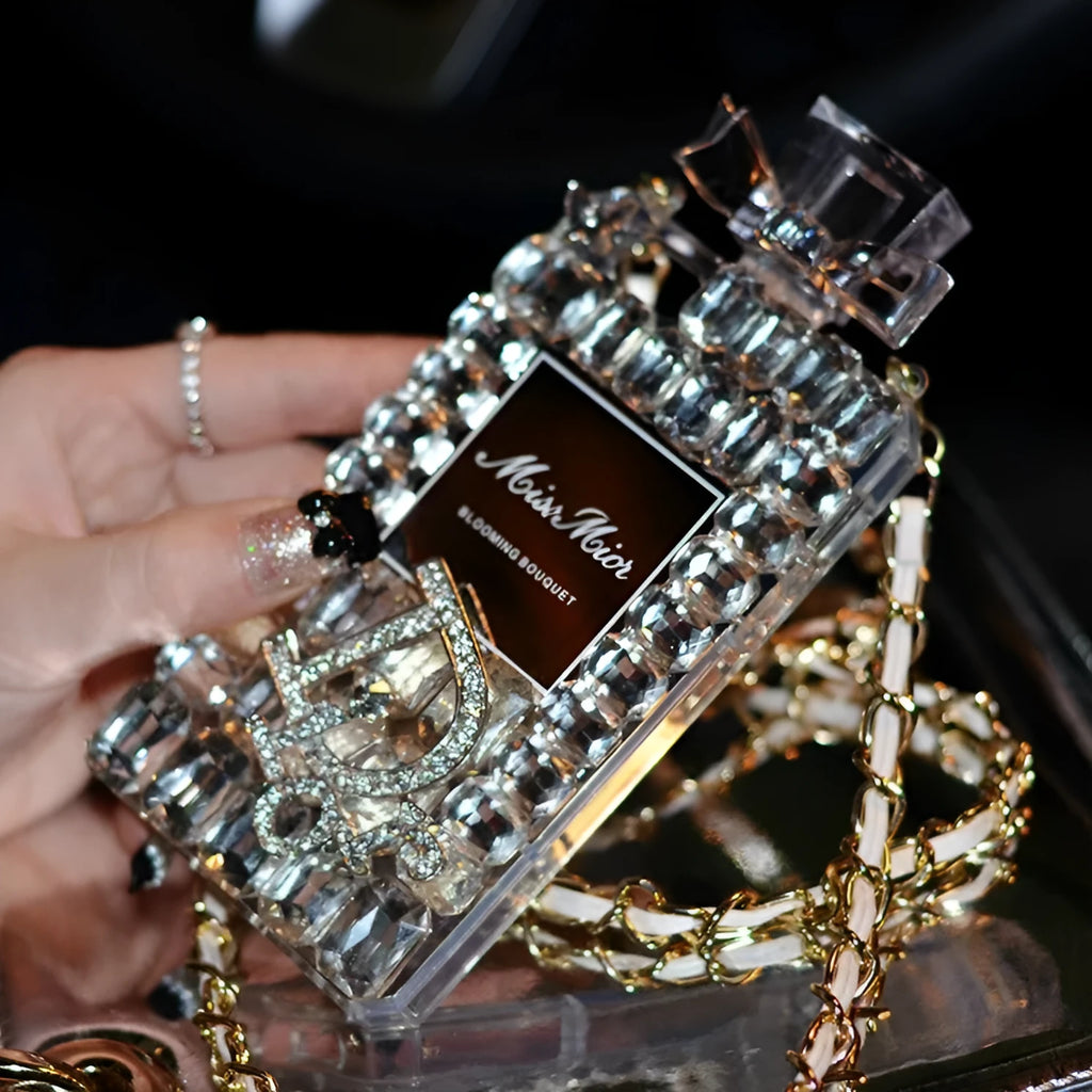 iPhone case with perfume bottle bow design, TPU silicone construction, and attached metal chain