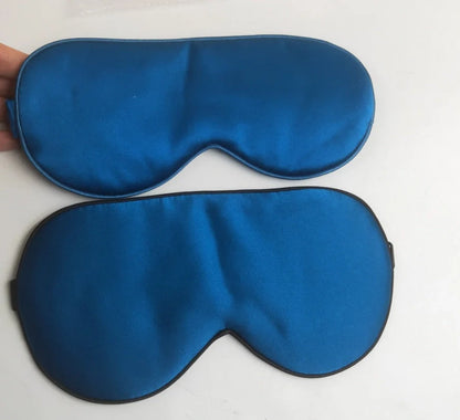 Silk double-sided eye mask in peacock blue and silver with adjustable strap, showing contoured nasal bridge design