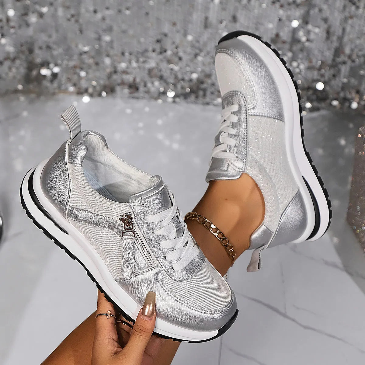 Gold women's flat lace-up pumps with round toe and shallow cut on a white background.