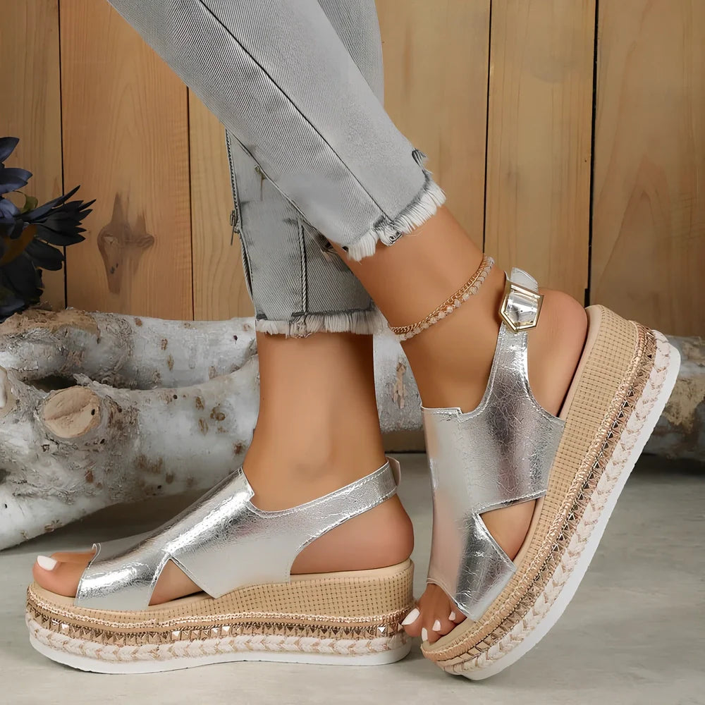 Women's gold fish mouth buckle wedges with hollow sides and 7 cm rubber heel on white background