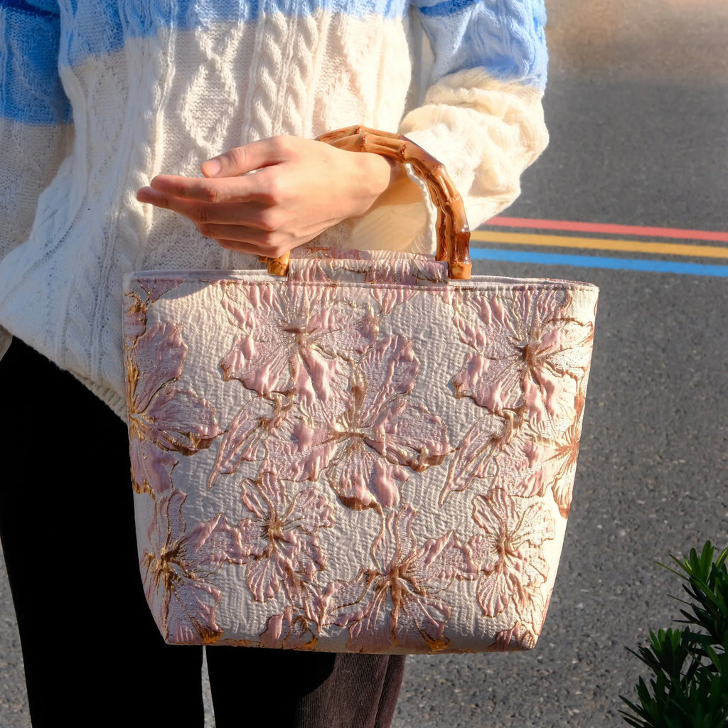 Light blue canvas bag with gold floral pattern showing double shoulder straps and square 30cm shape