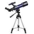 Dark blue and white children's monocular astronomical telescope with tripod on a table.