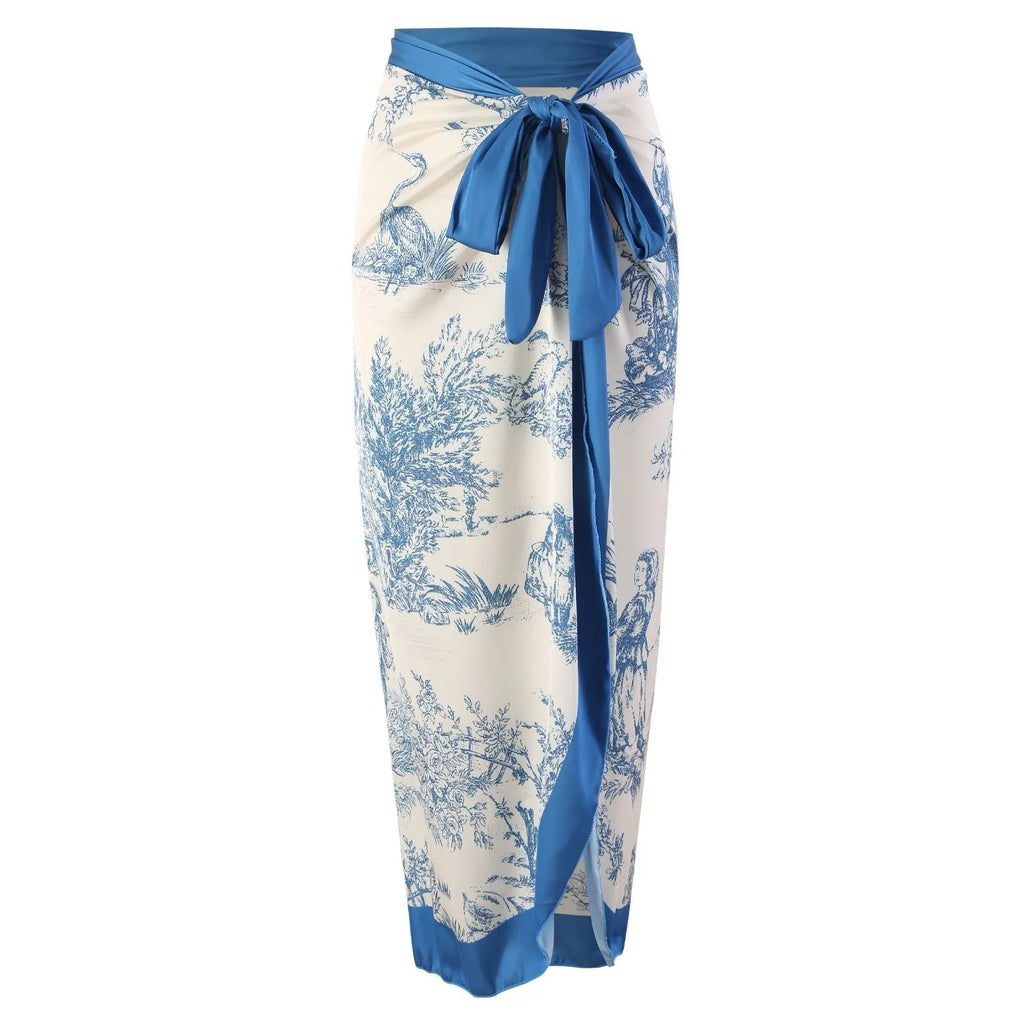 Blue women's one-piece polyester swimsuit with matching gauze skirt laid flat