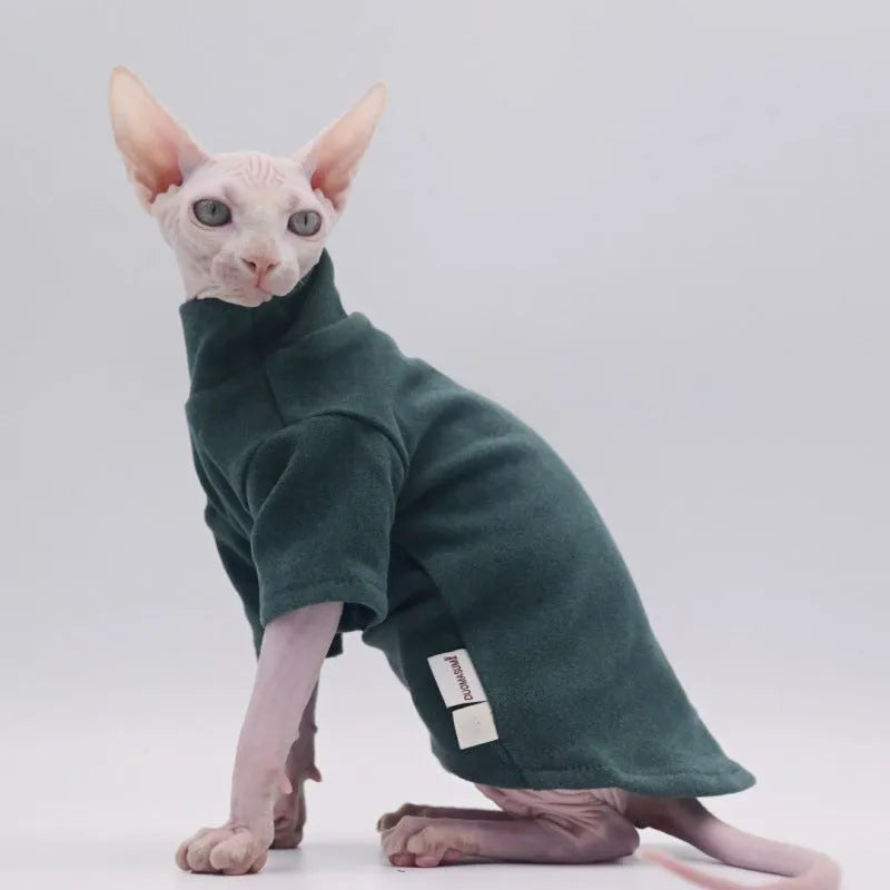 Hairless cat wearing a polar fleece hoodie in autumn winter colours black gray green purple with hood up