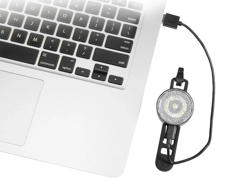 Bicycle LED headlight with clip attachment showing lens reflectors and USB port for charging