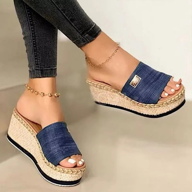 Platform wedge heel sandals with cloth upper in black, side view showing plain pattern and metal element detail