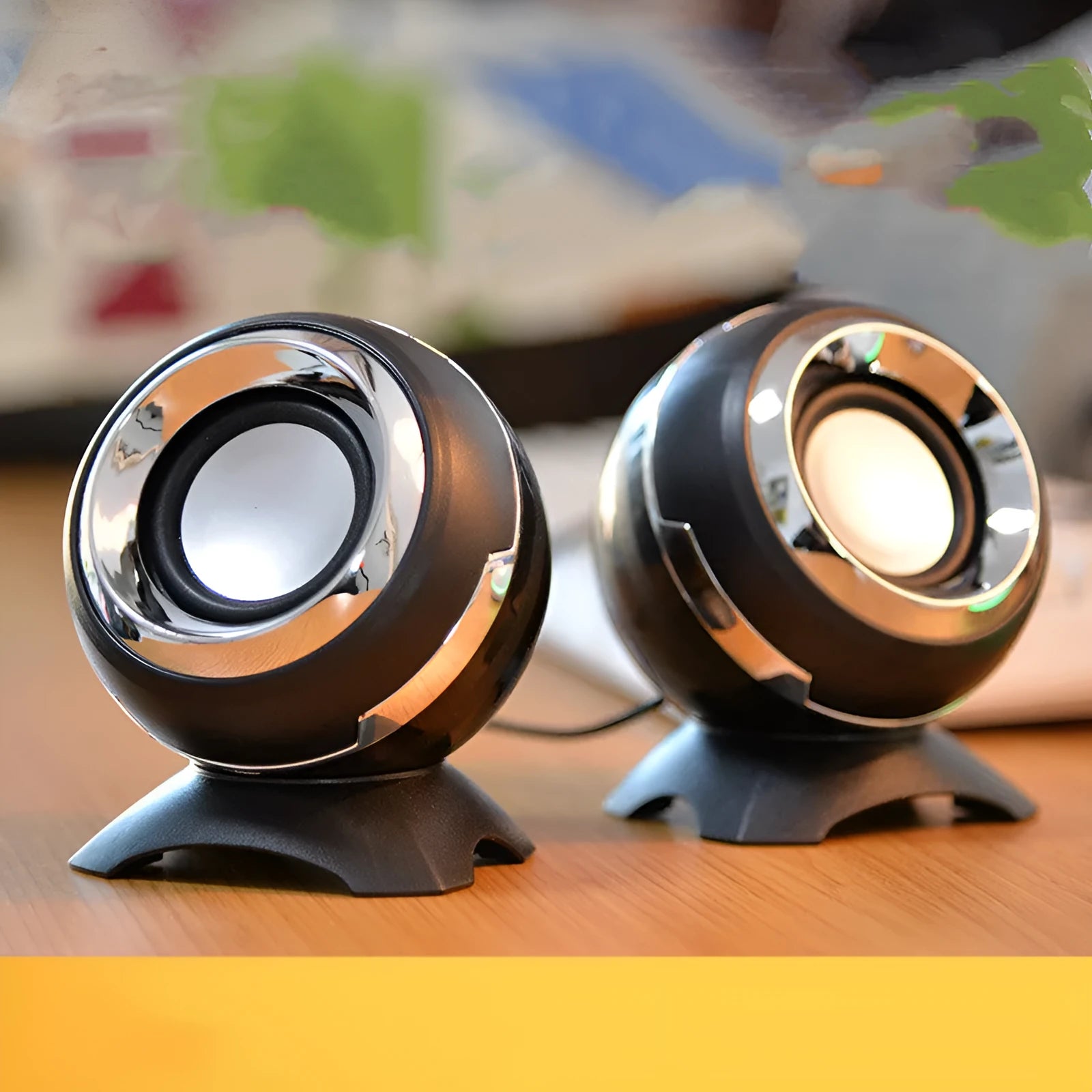 Compact black and gold USB-powered stereo desktop speakers next to a laptop.