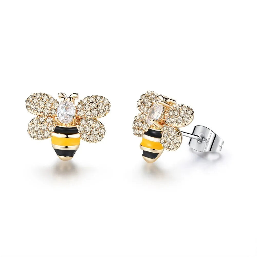 Three styles of Korean inlaid crystal rhinestone bee and flower stud earrings on a white background