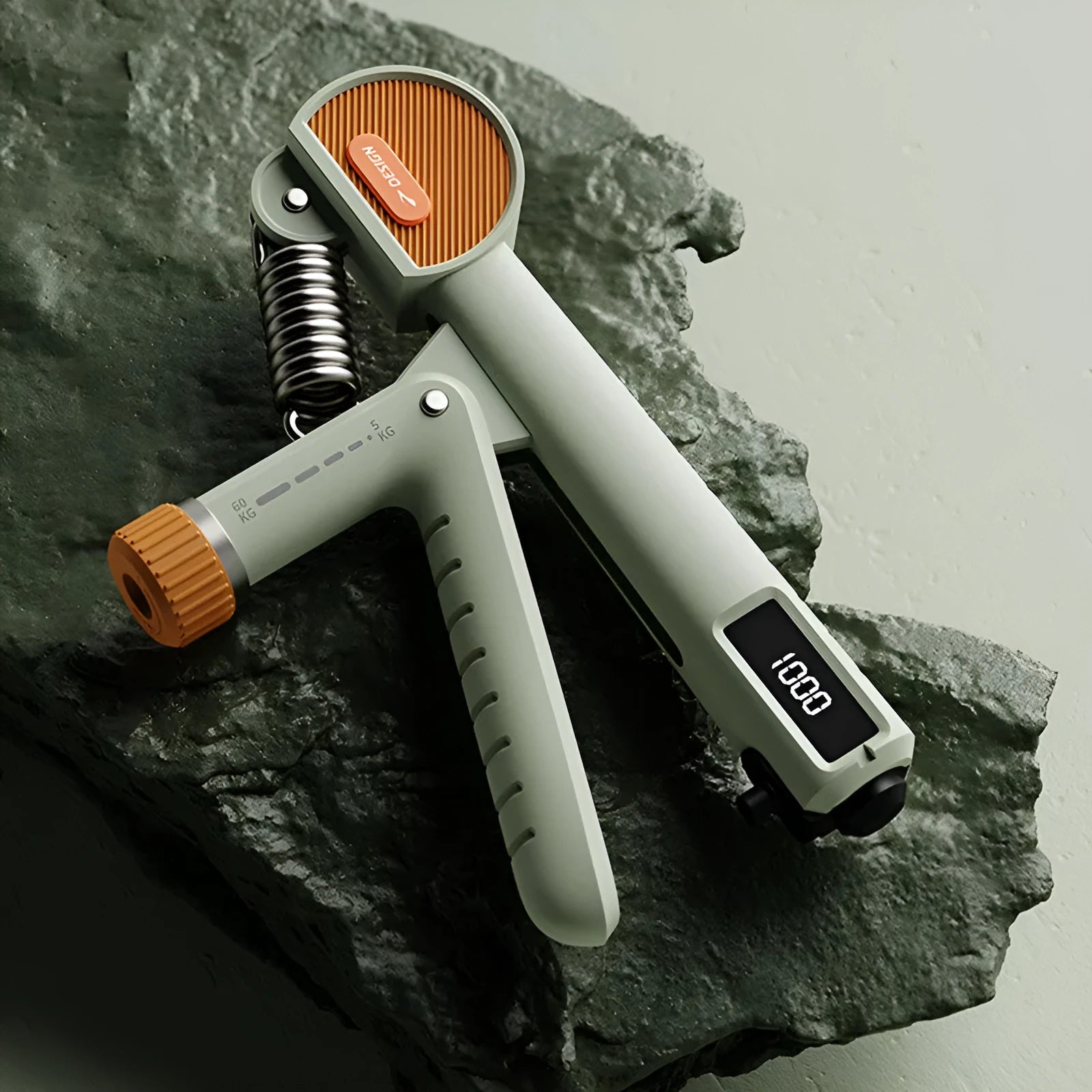 Adjustable spring grip strengthener in ABS plastic available in ivory white, dark black, or green colours