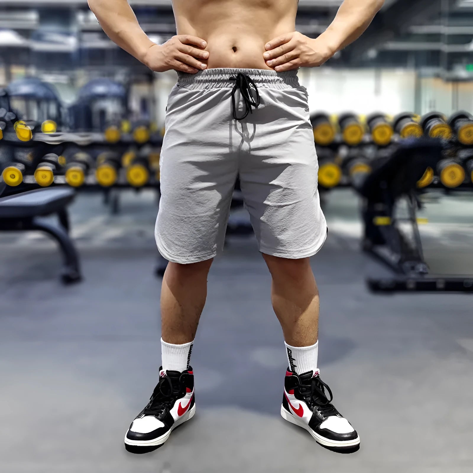 Men's black quick-dry running shorts made of nylon and spandex on a grey background