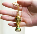 World Cup keychain made of synthetic resin featuring football-themed design on a white background.
