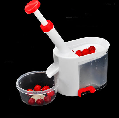 White cherry nucleator fruit cutter with stainless steel blades and plunger mechanism for cutting grapes