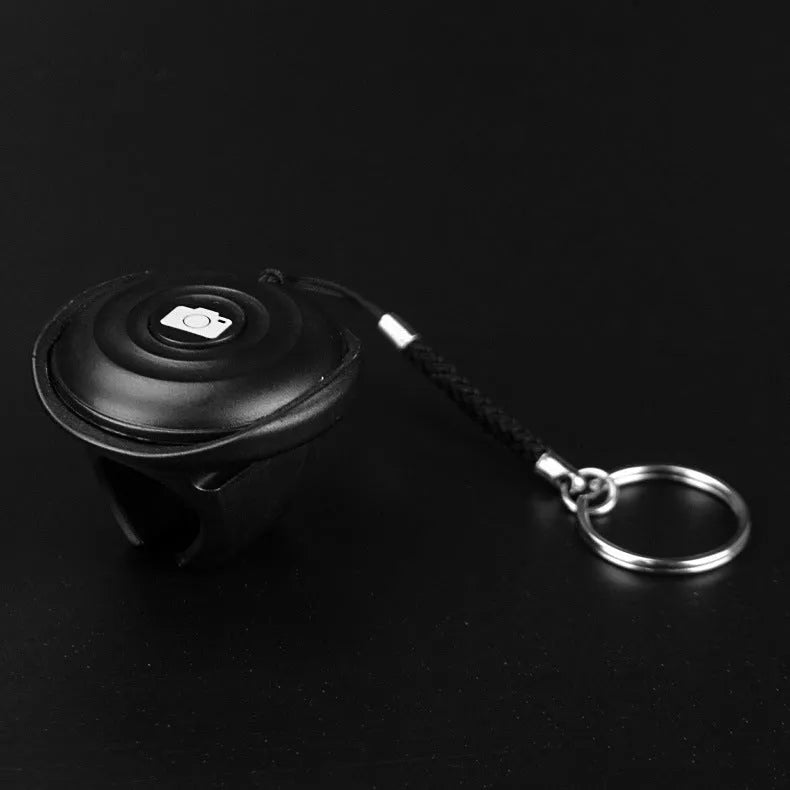 Black Snap Bluetooth remote control for wireless camera shutter and selfie triggering.