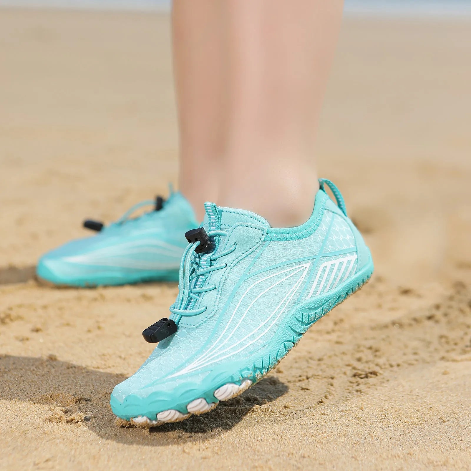 Children's blue swimming shoes with non-slip rubber soles and elastic band closure for beach and pool use