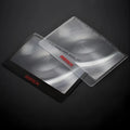 Black and white portable plastic card magnifier for reading and outdoor use.