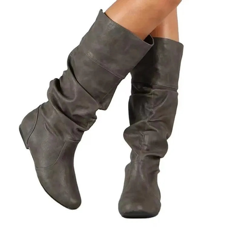 Women's black slip-on flat ankle boots with round toe and high calf.
